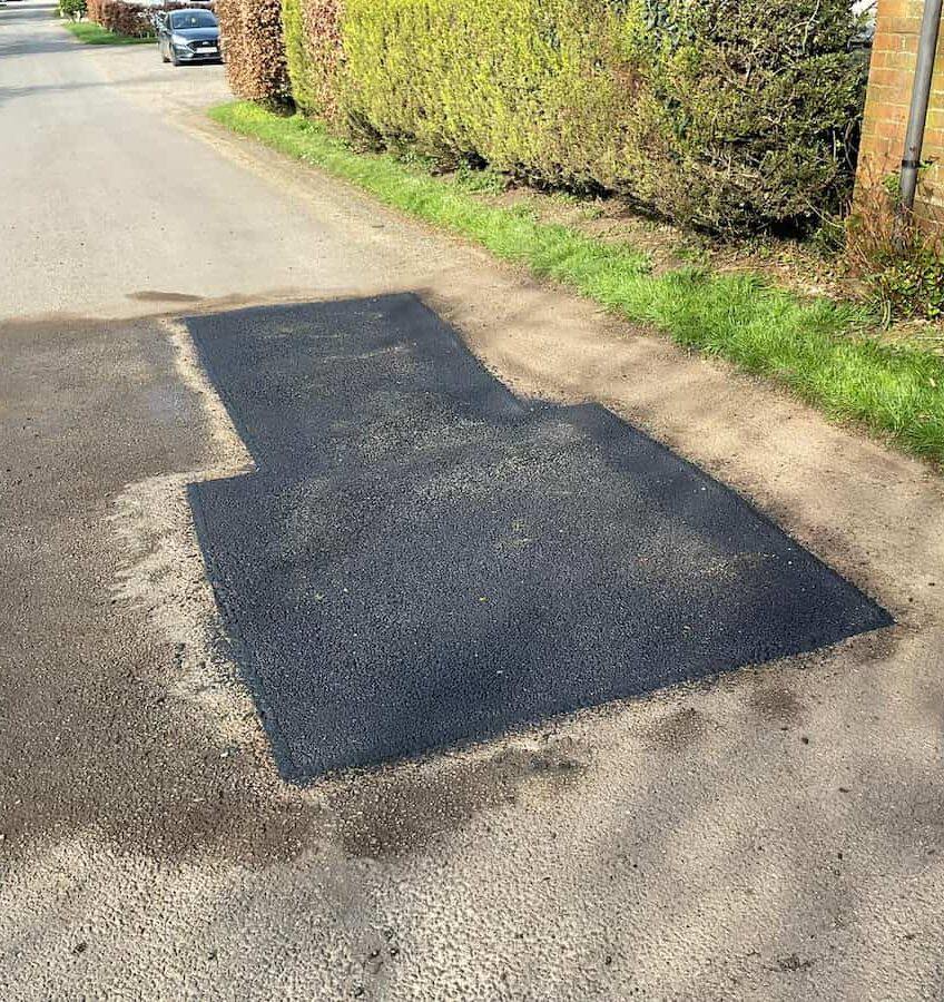 Pothole repairs in the West Midlands on a damaged tarmac surface